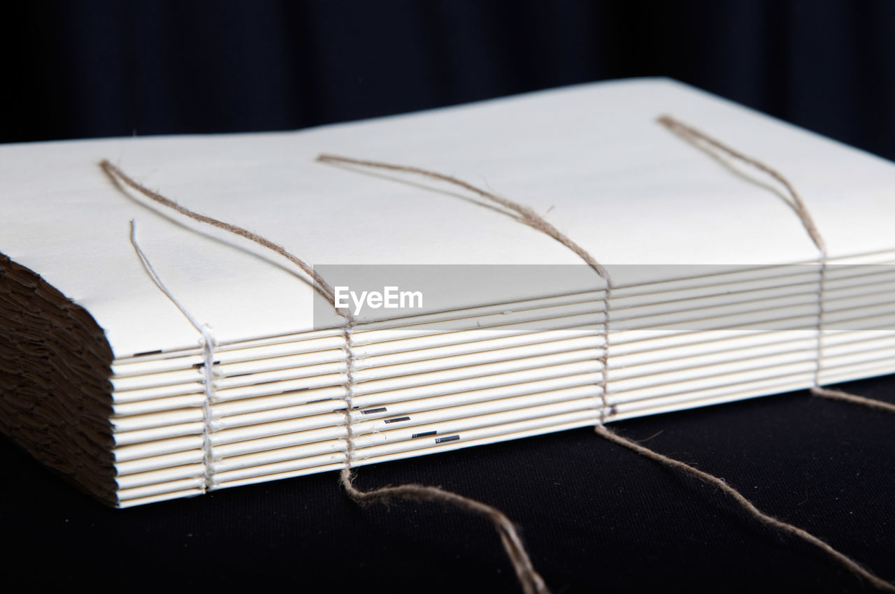 CLOSE-UP OF BOOK ON TABLE