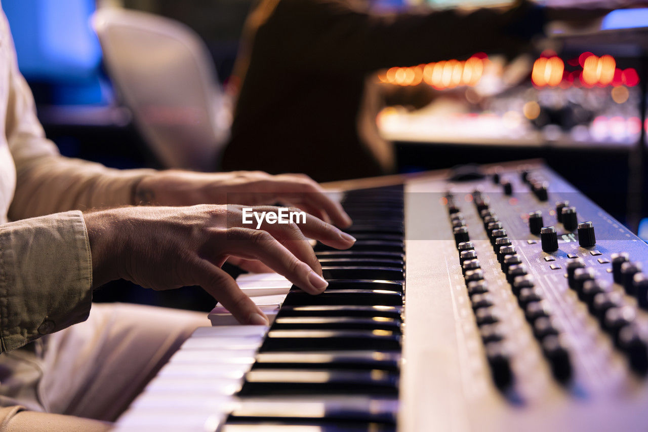 cropped image of woman playing piano