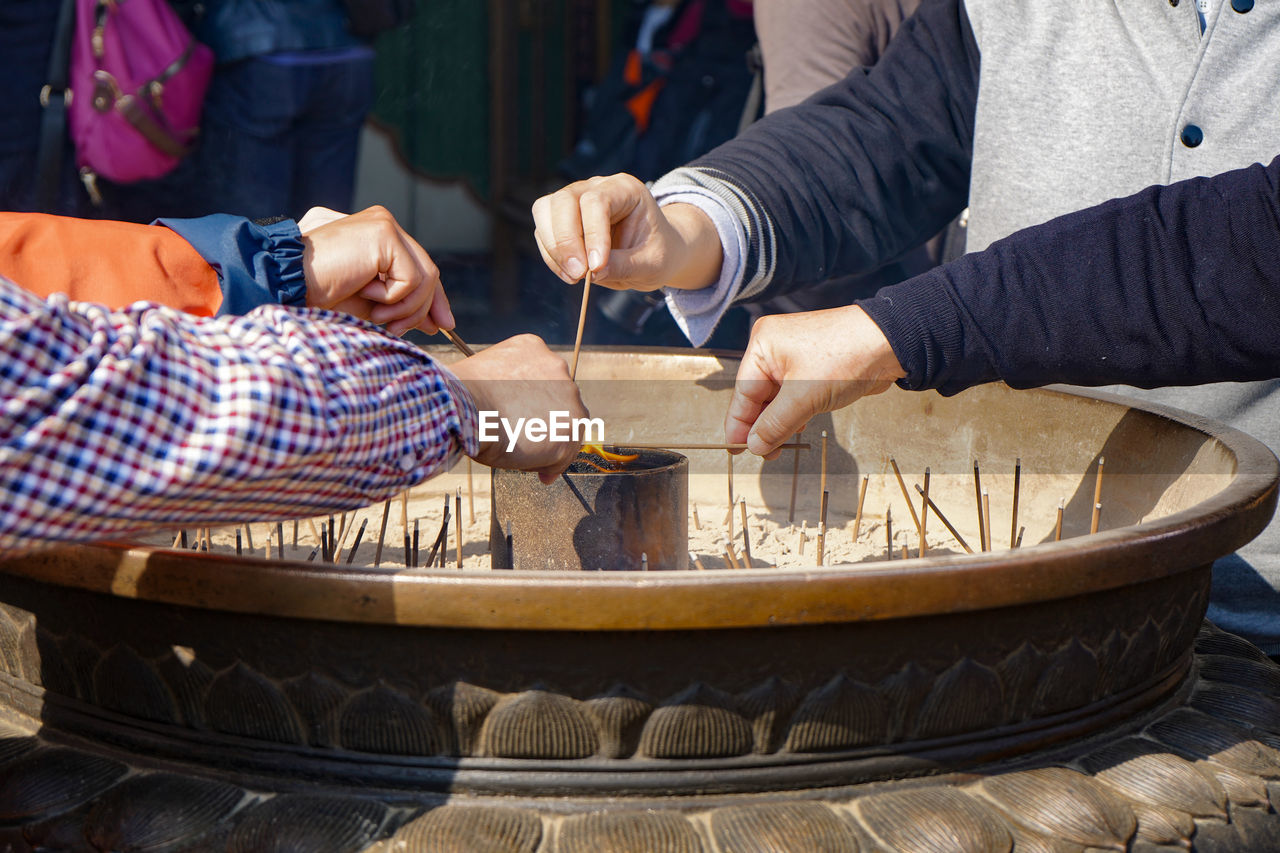 People burning incense at temple