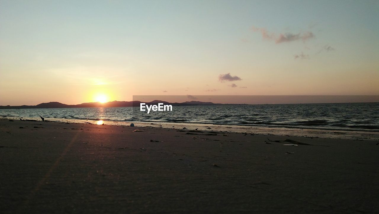 SCENIC VIEW OF BEACH DURING SUNSET