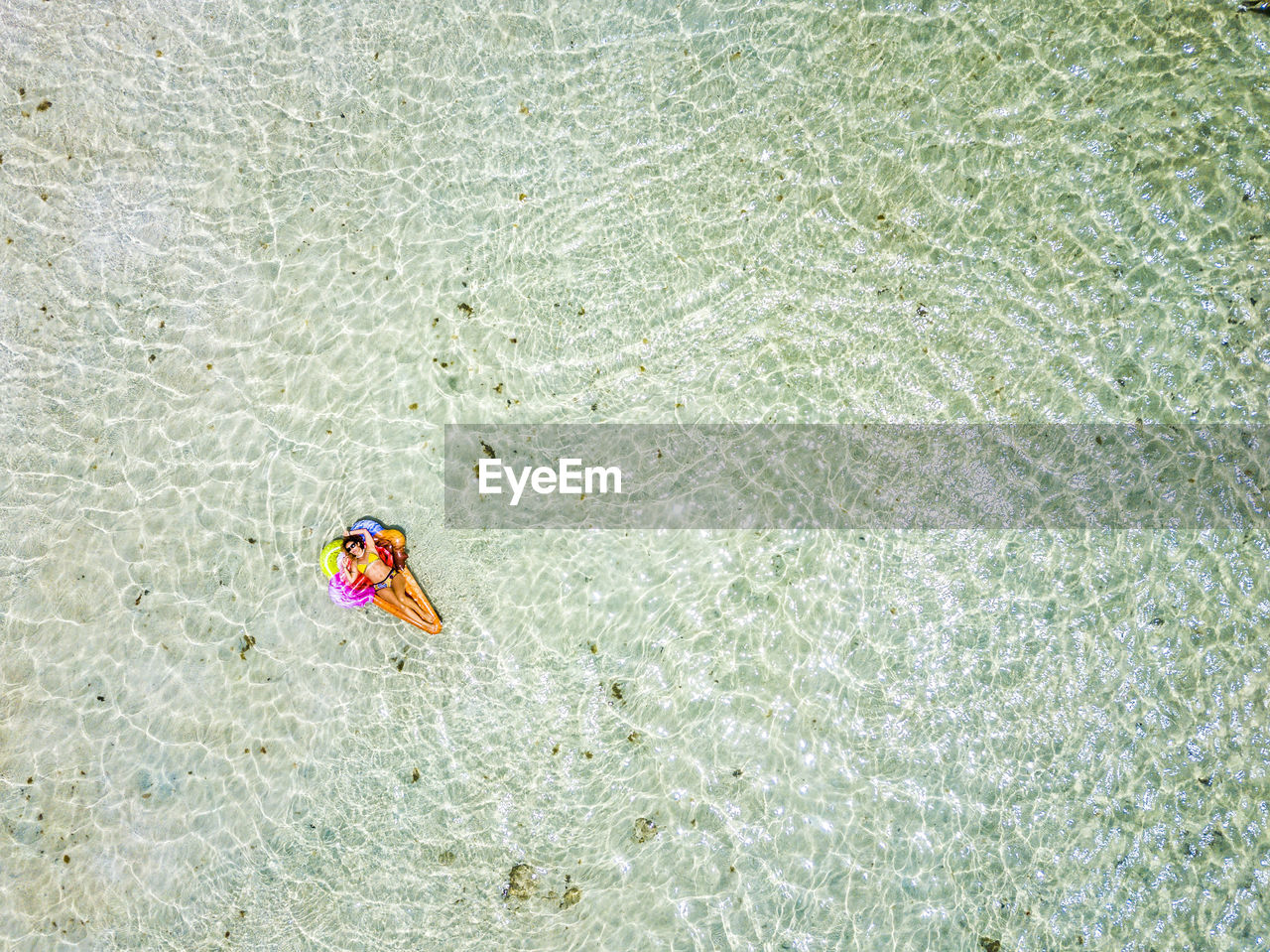 Aerial view of woman swimming in sea