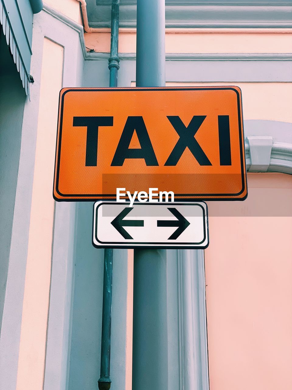 Taxi orange sign closeup in a street with natural light and copy space 