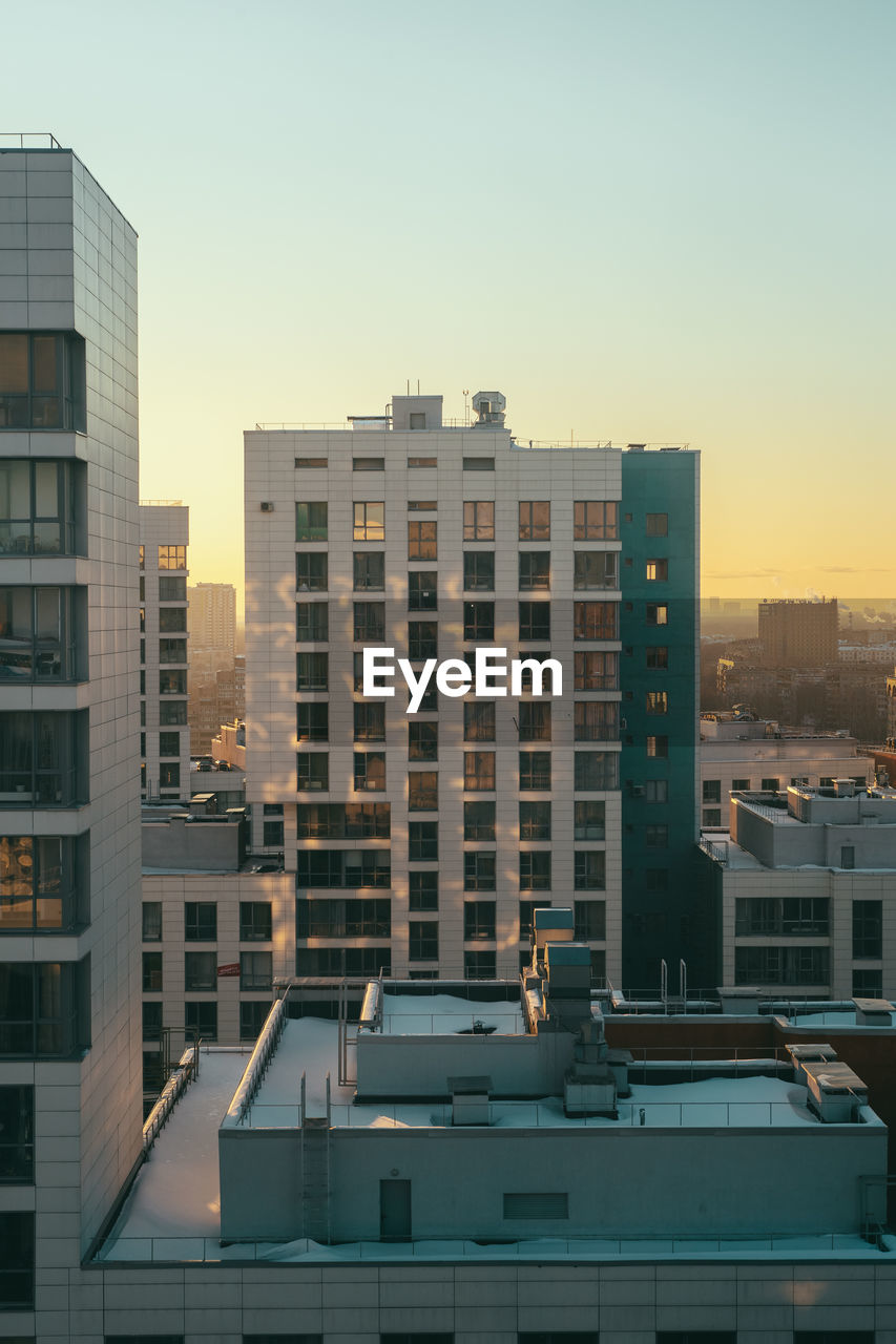 BUILDINGS AGAINST SKY DURING SUNSET