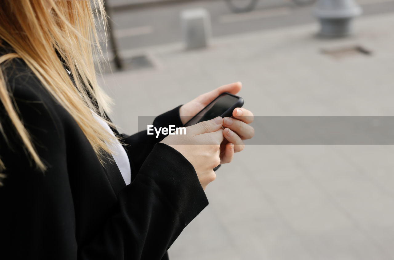 Close up of women's hands texting on mobile phone
