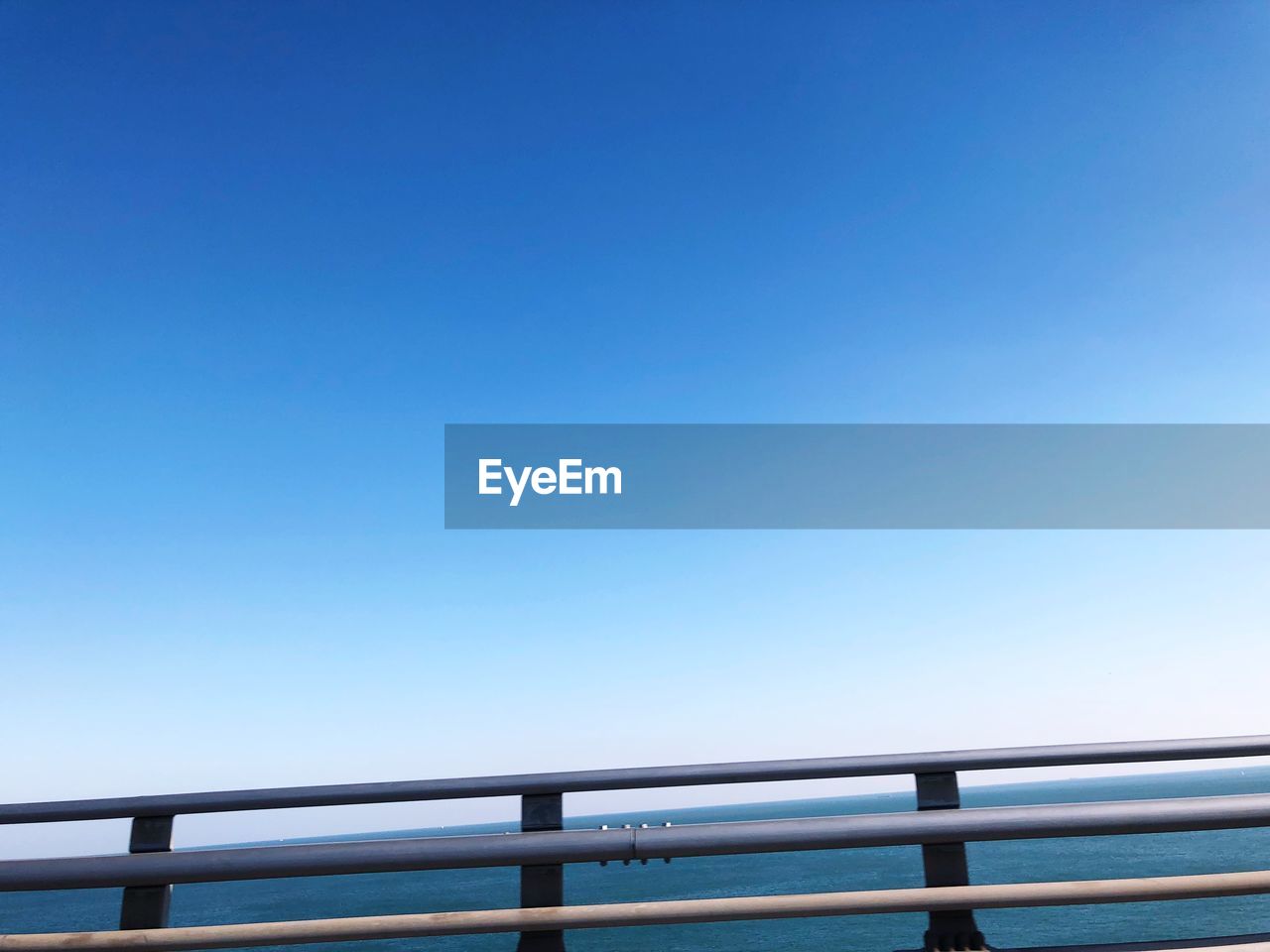 Low angle view of bridge against clear blue sky