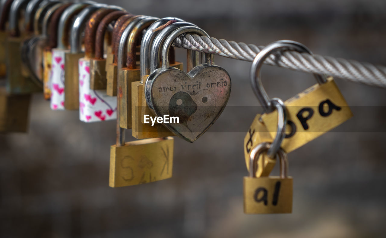 Close-up of padlocks hanging on railing