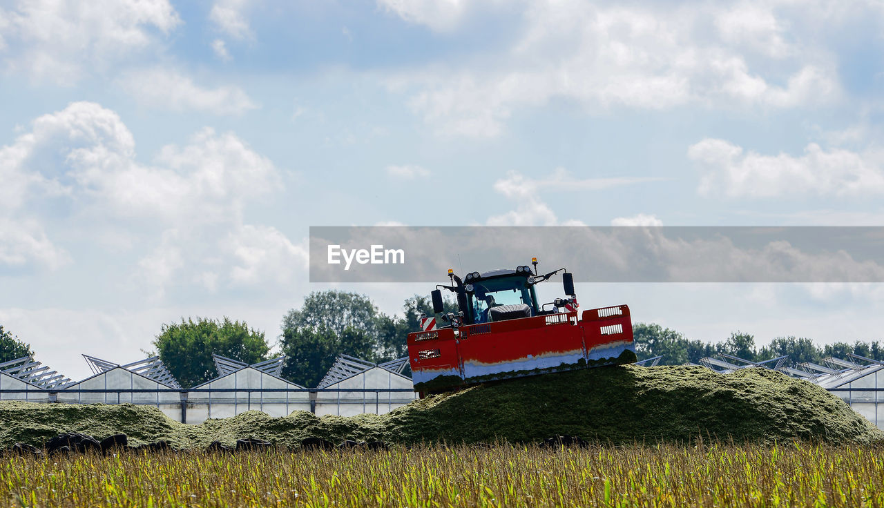 Tractor on field against sky