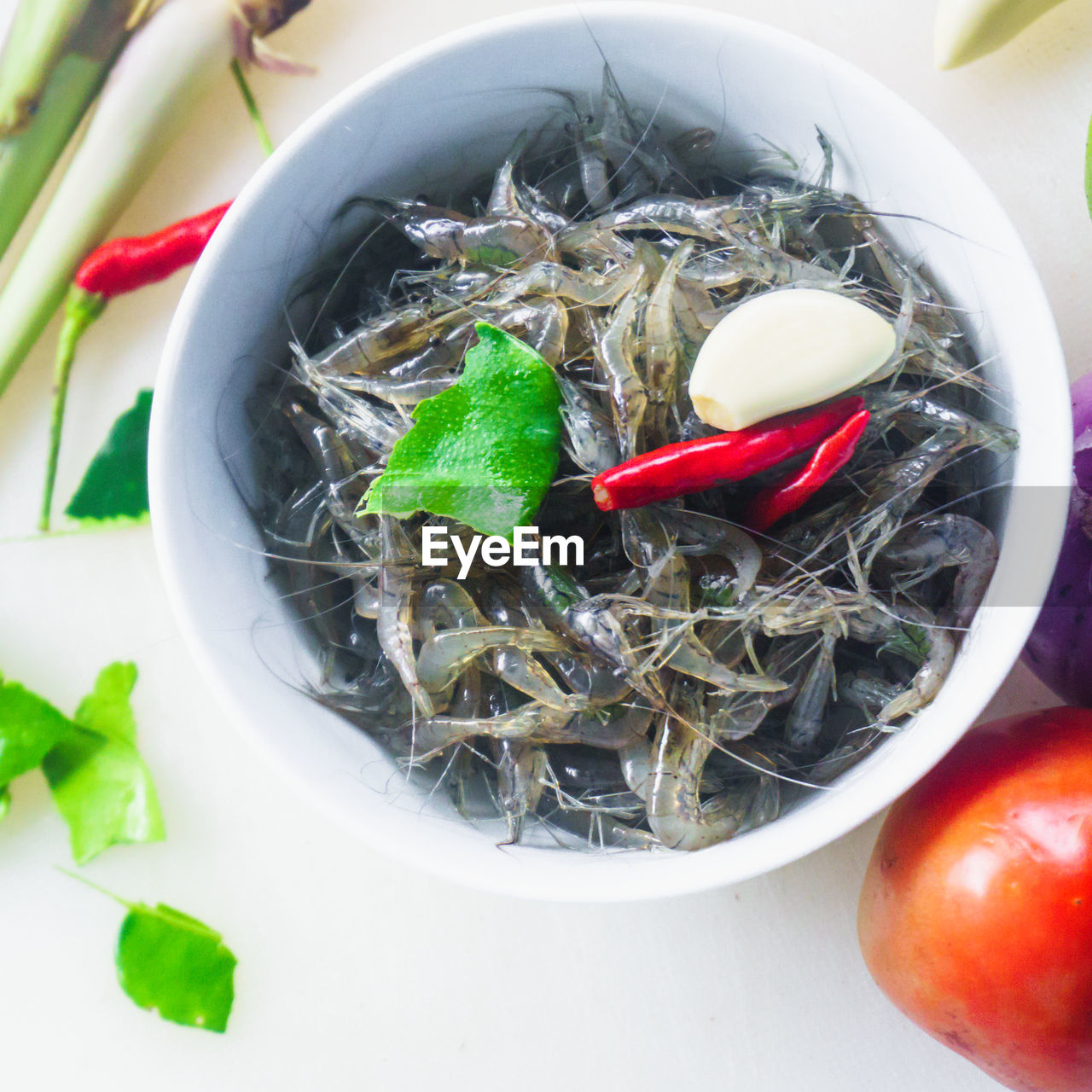 Close-up of fishes and vegetables in bowl over table