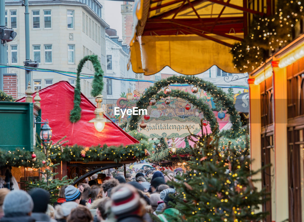 People in illuminated city during christmas