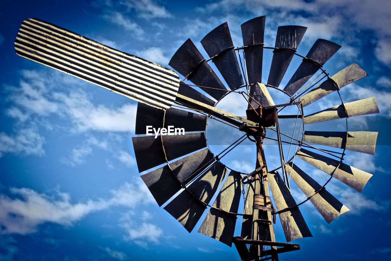 Low angle view of traditional windmill against sky