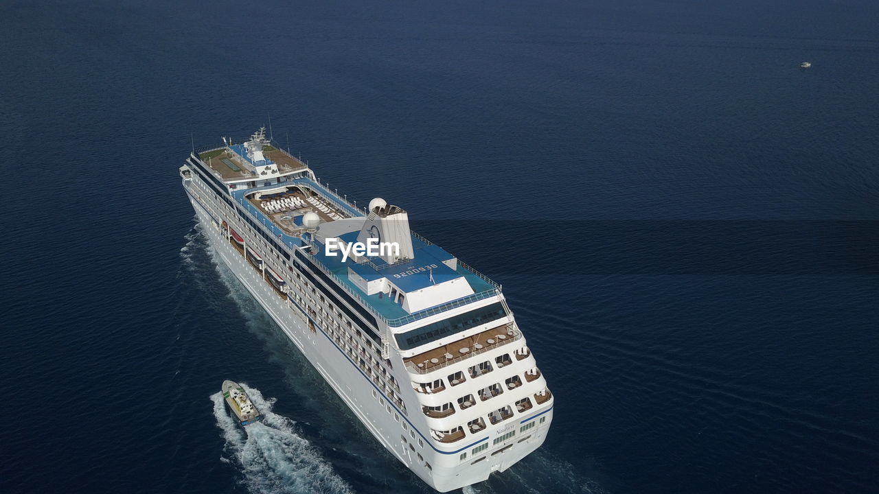 HIGH ANGLE VIEW OF ILLUMINATED SHIP SAILING ON SEA