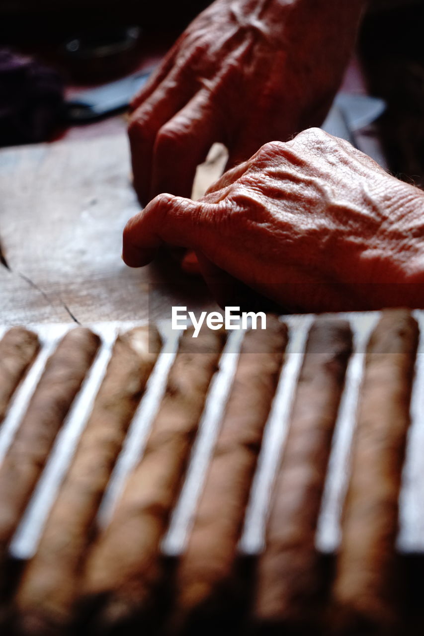 HIGH ANGLE VIEW OF PERSON PREPARING MEAT