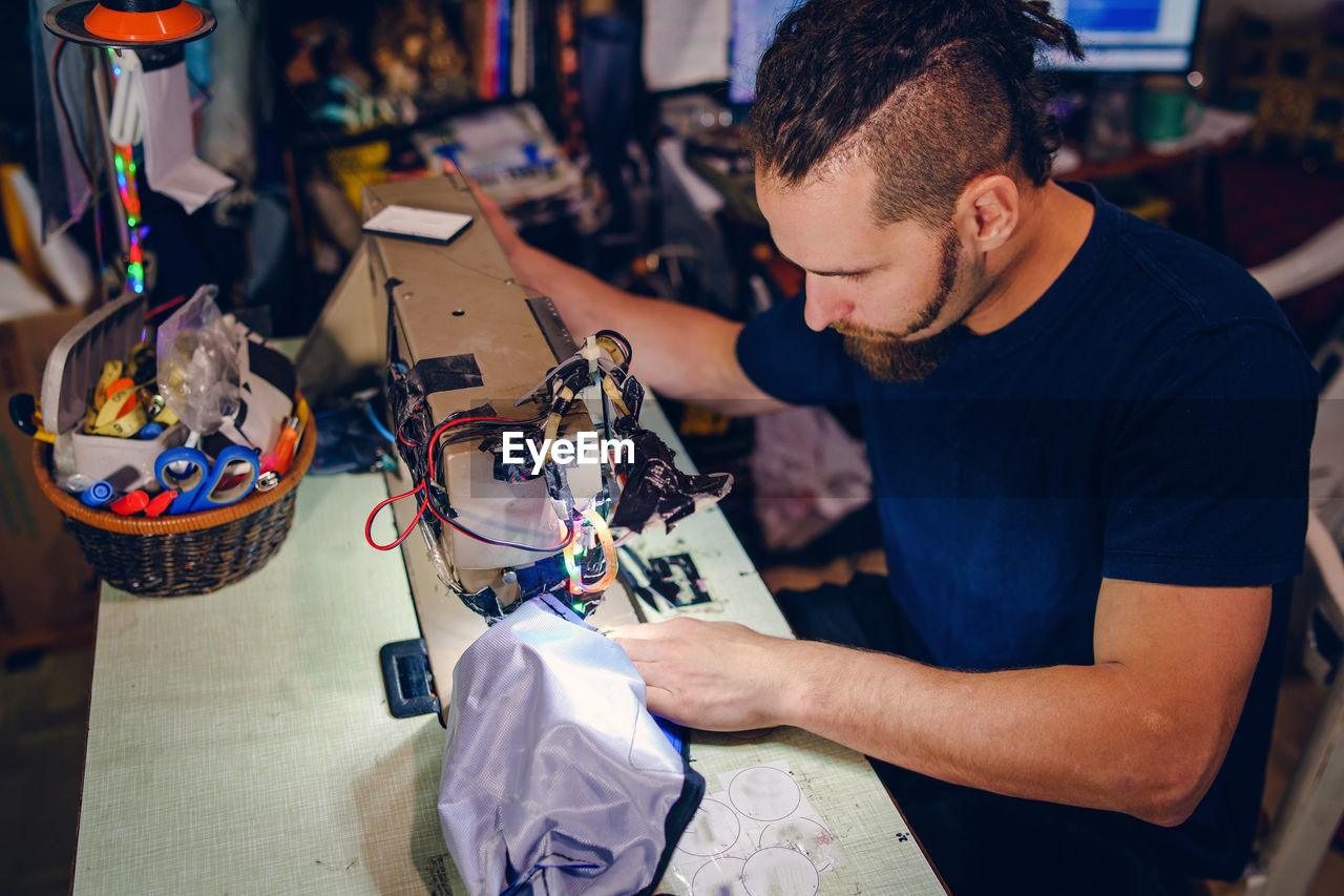 Man working on sewing machine