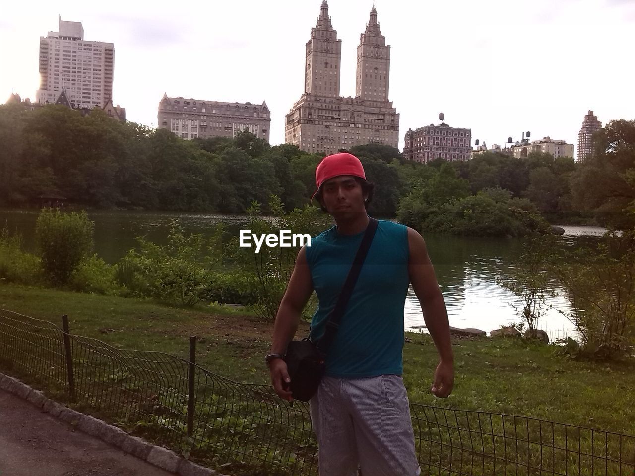 MAN STANDING AGAINST SKY IN CITY