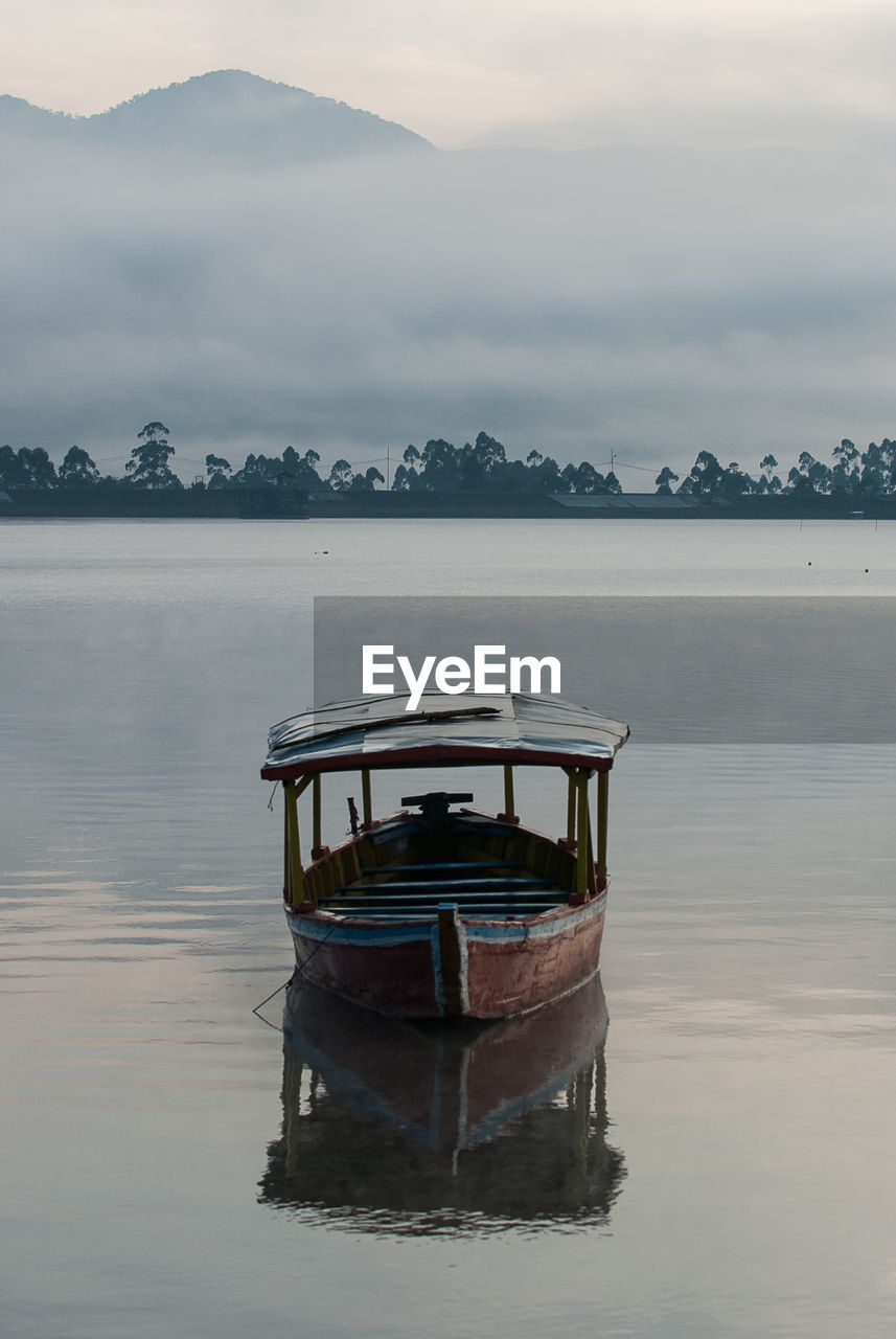 Boat in lake against sky