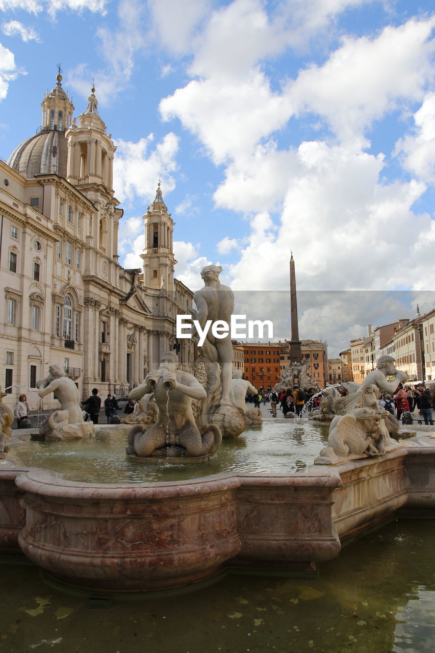 Sunny view of piazza navona with the moor fountain or fontana del moro and tourists