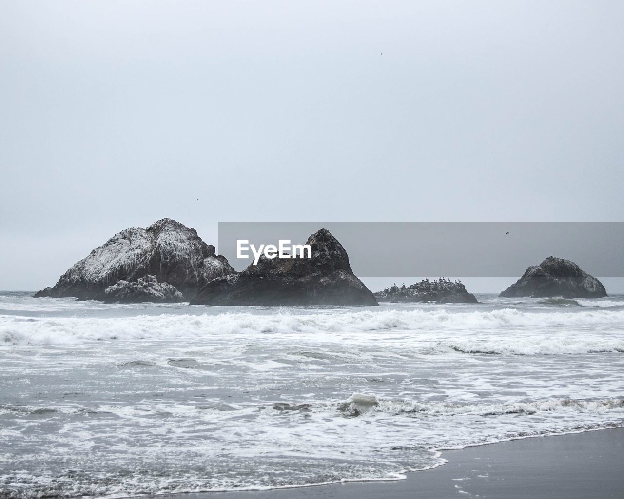 Scenic view of sea with mountain in background