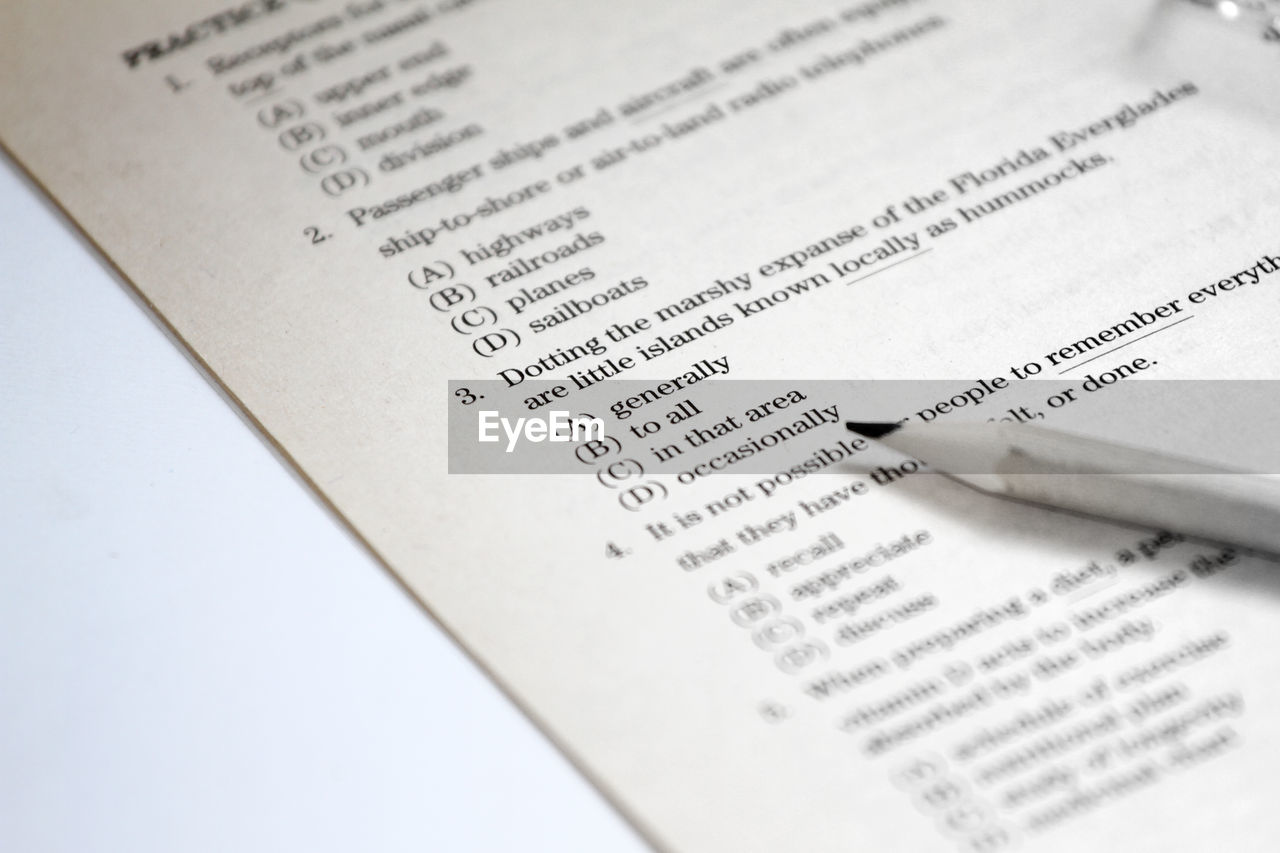 Close-up of book by pencil on table