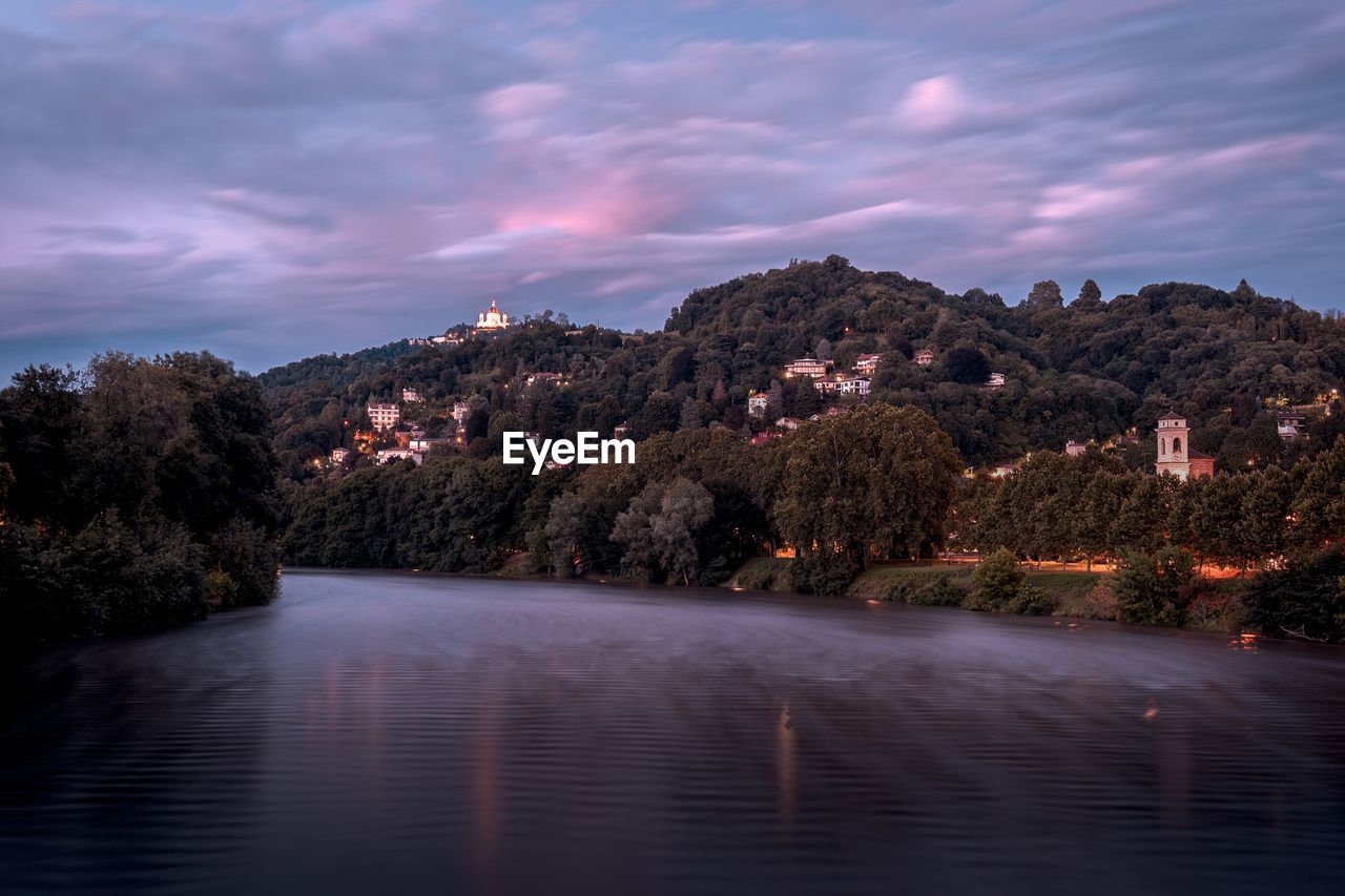 Scenic view of lake against sky at sunset