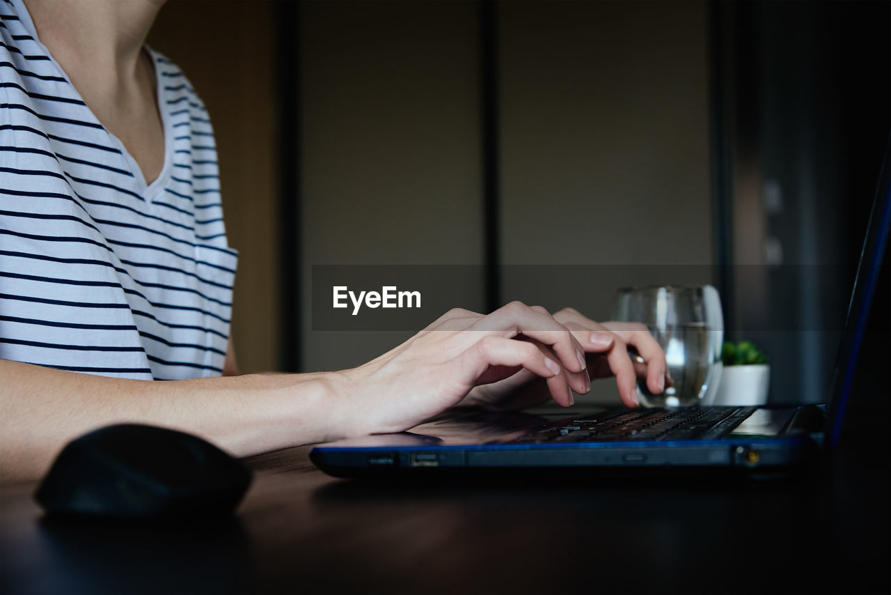 Caucasian woman typing with laptop keyboard at home office workplace. freelancer remotely working