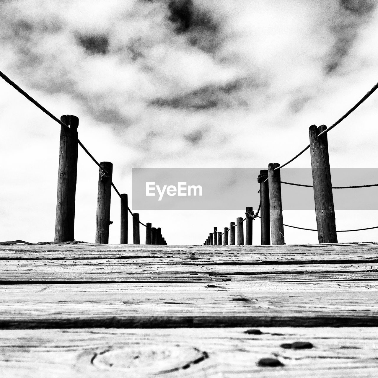 LOW ANGLE VIEW OF METALLIC BRIDGE AGAINST SKY