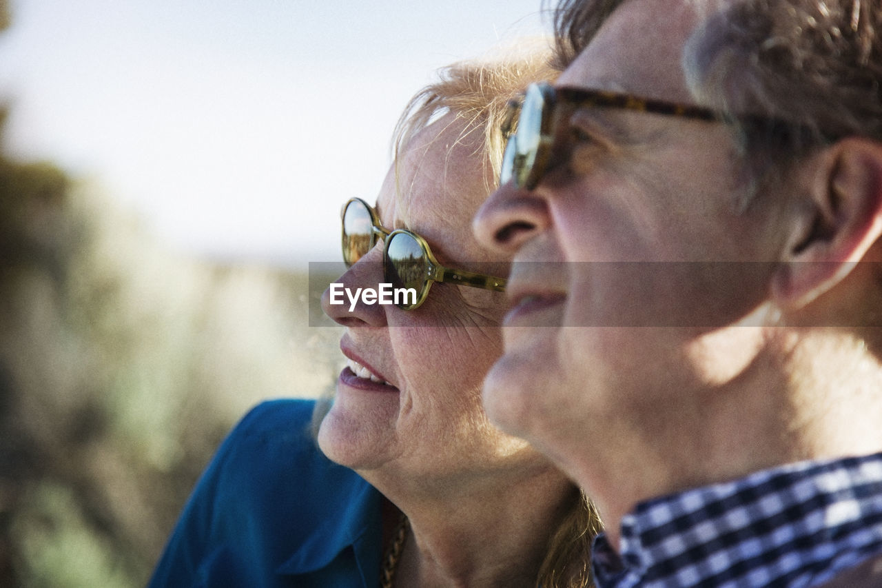 Close-up of senior couple looking away