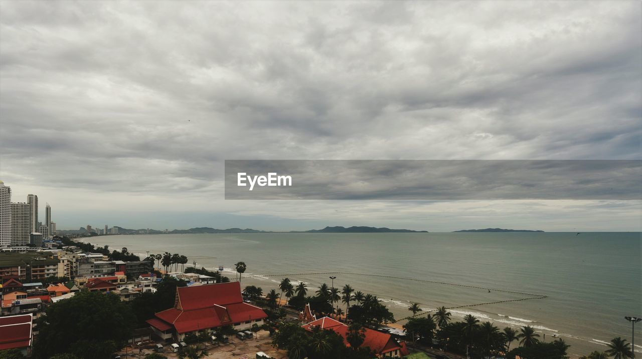 High angle view of buildings and sea against sky