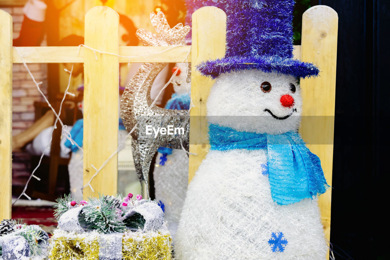 representation, no people, human representation, celebration, creativity, toy, craft, flower, holiday, art, snowman, decoration, multi colored, animal representation, smiling, day, nature, tradition, outdoors, blue, close-up, winter, clothing, yellow