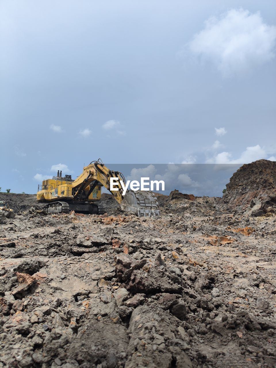 sky, cloud, industry, construction industry, nature, environment, rock, soil, mountain, construction machinery, geology, sea, no people, construction site, earth mover, land, mining, environmental issues, landscape, outdoors, day, machinery, coast, transportation, architecture