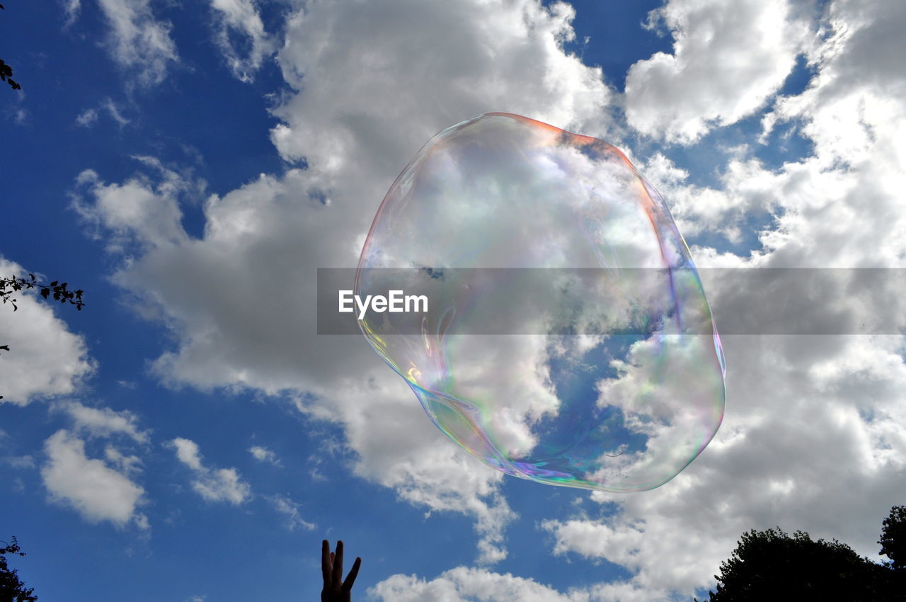LOW ANGLE VIEW OF BUBBLE AGAINST SKY