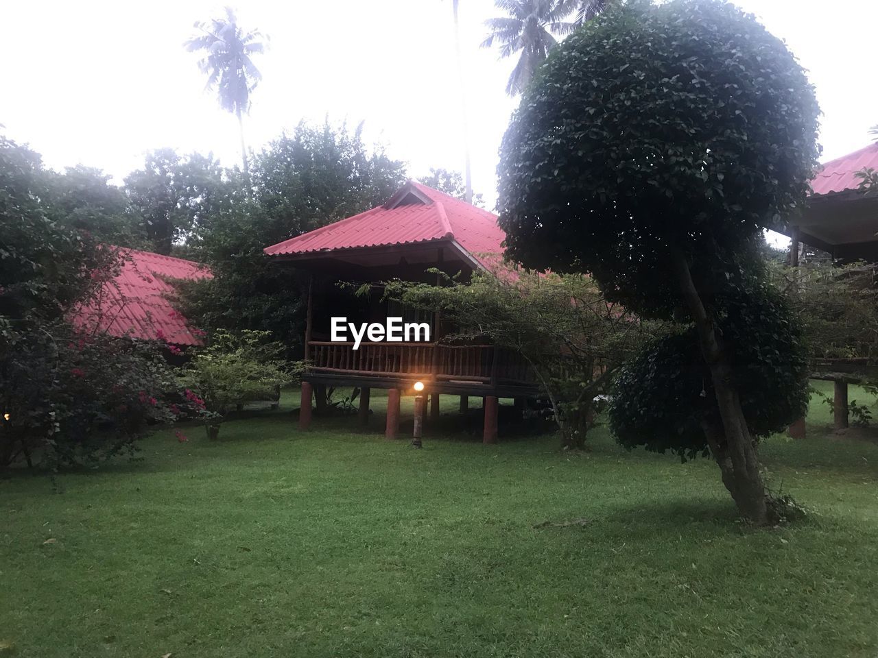 HOUSE ON FIELD AGAINST SKY