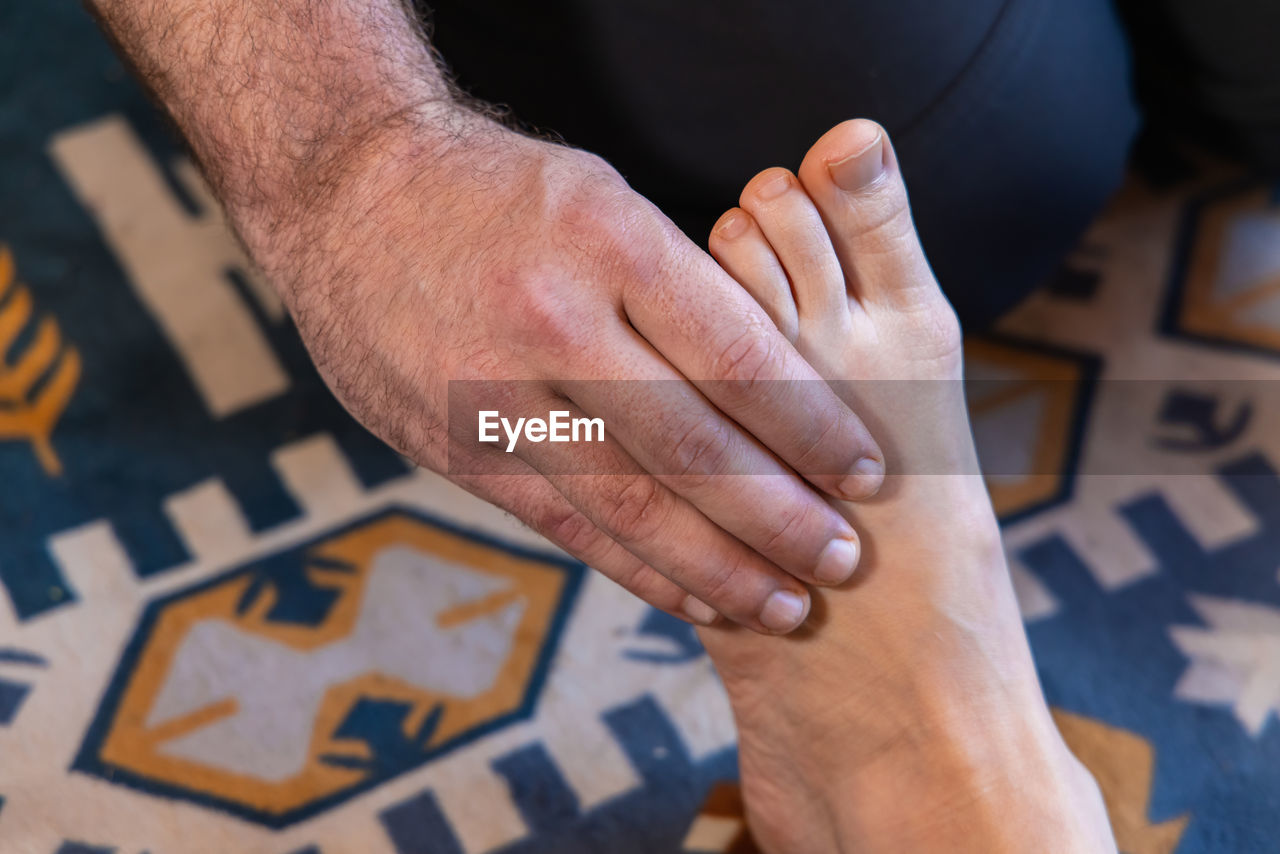 cropped image of man holding jigsaw pieces