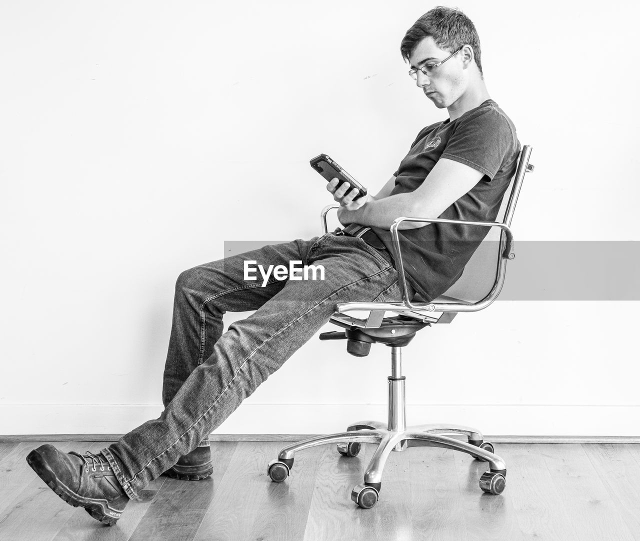 MAN SITTING ON CHAIR AT HOME