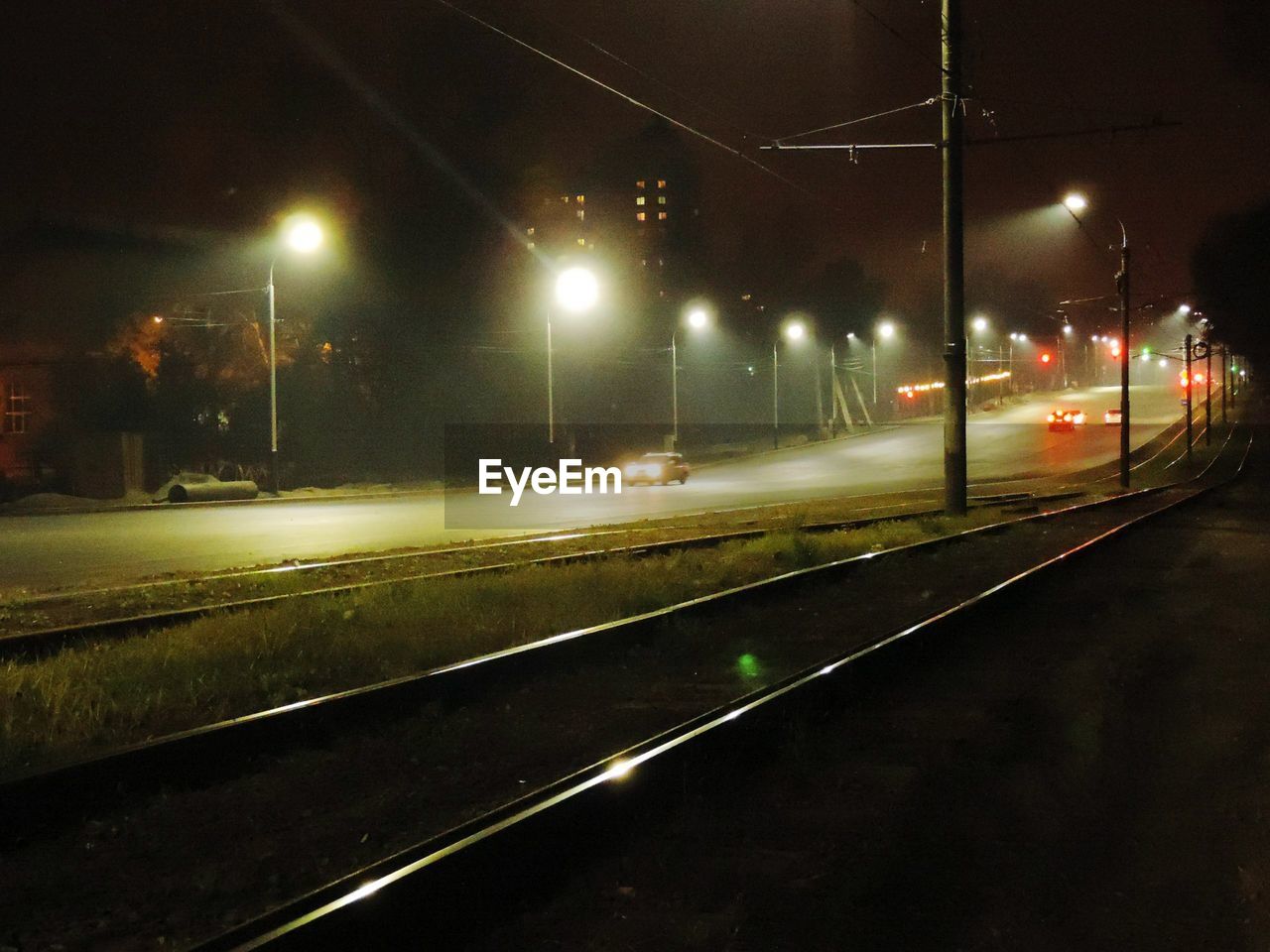 ILLUMINATED RAILROAD TRACKS AT NIGHT