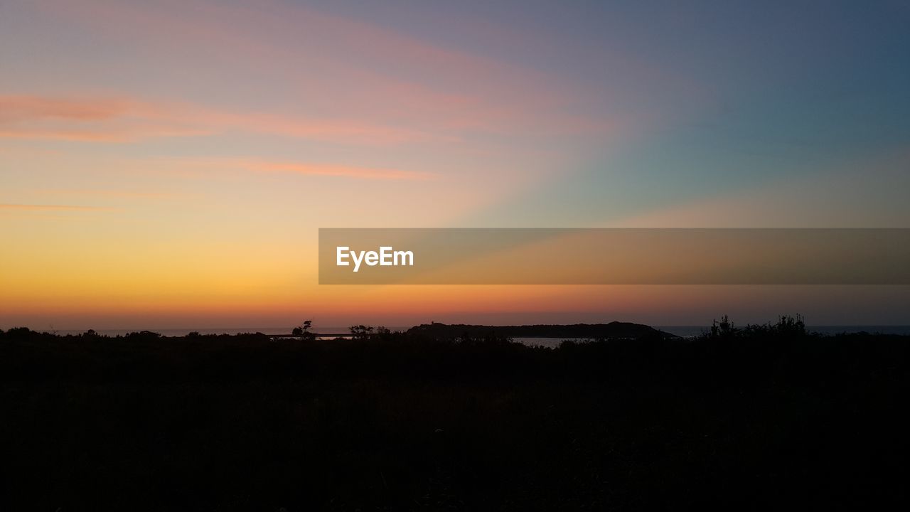 SILHOUETTE LANDSCAPE AGAINST SKY DURING SUNSET