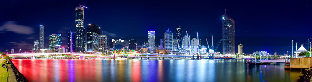 ILLUMINATED MODERN BUILDINGS AT NIGHT