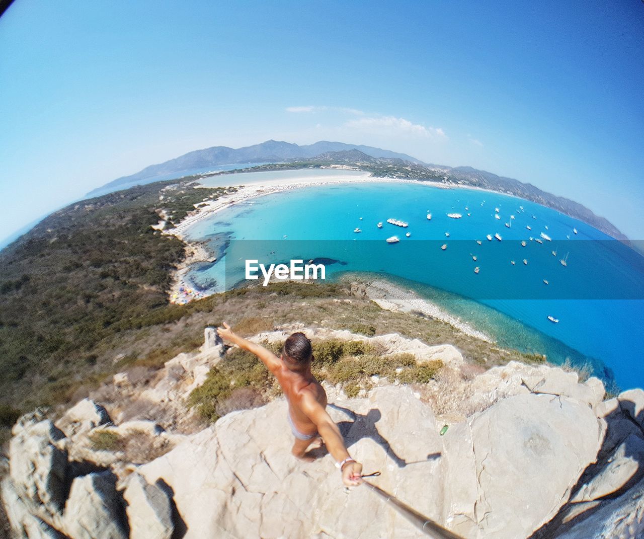 MAN SWIMMING IN SEA AGAINST CLEAR SKY