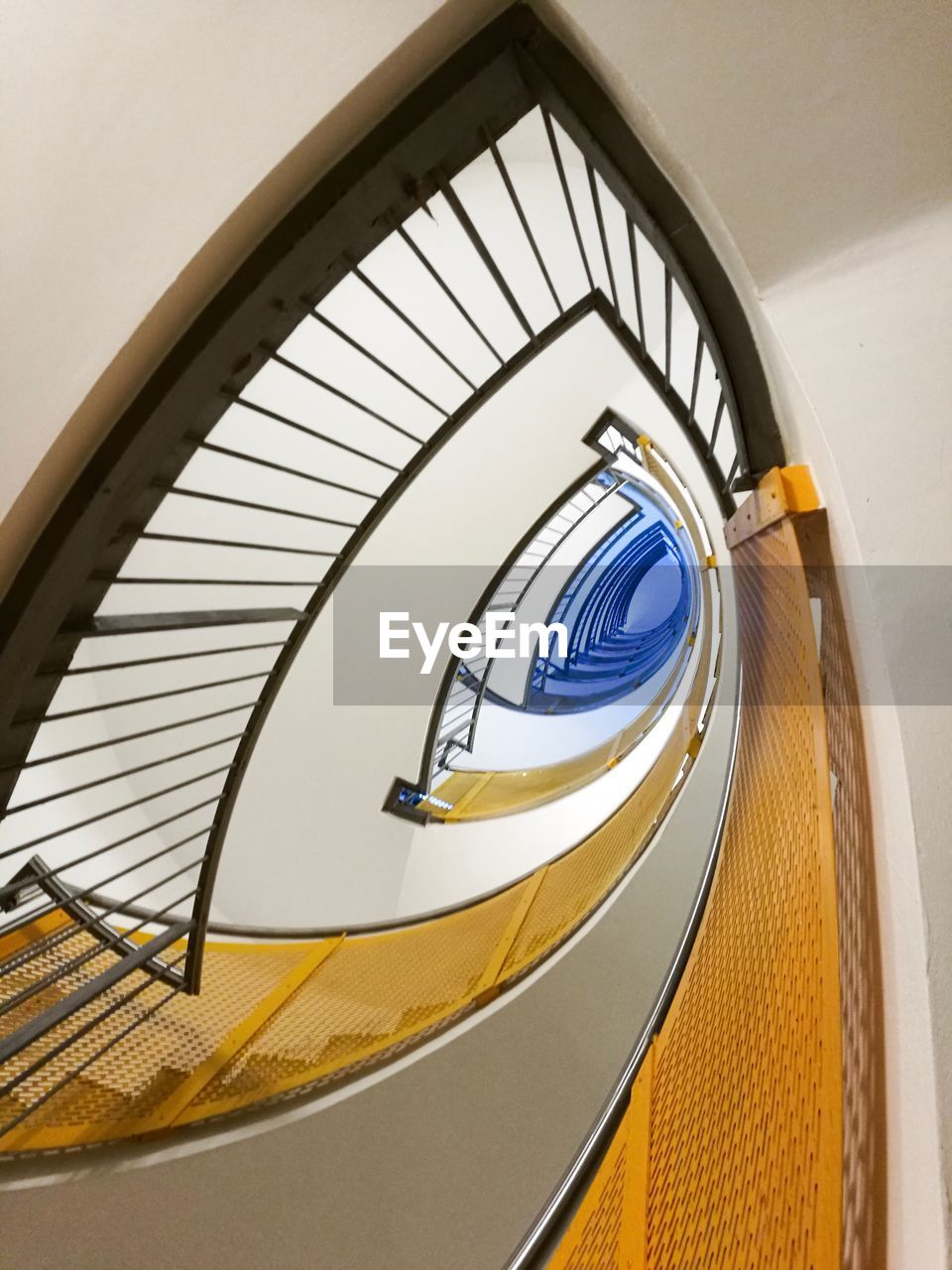 LOW ANGLE VIEW OF STAIRS IN SPIRAL STAIRCASE