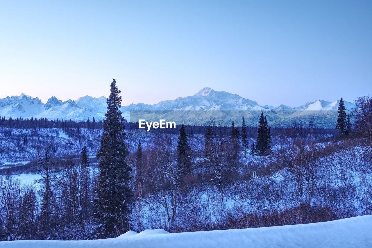 Scenic view of snowcapped mountains against clear sky