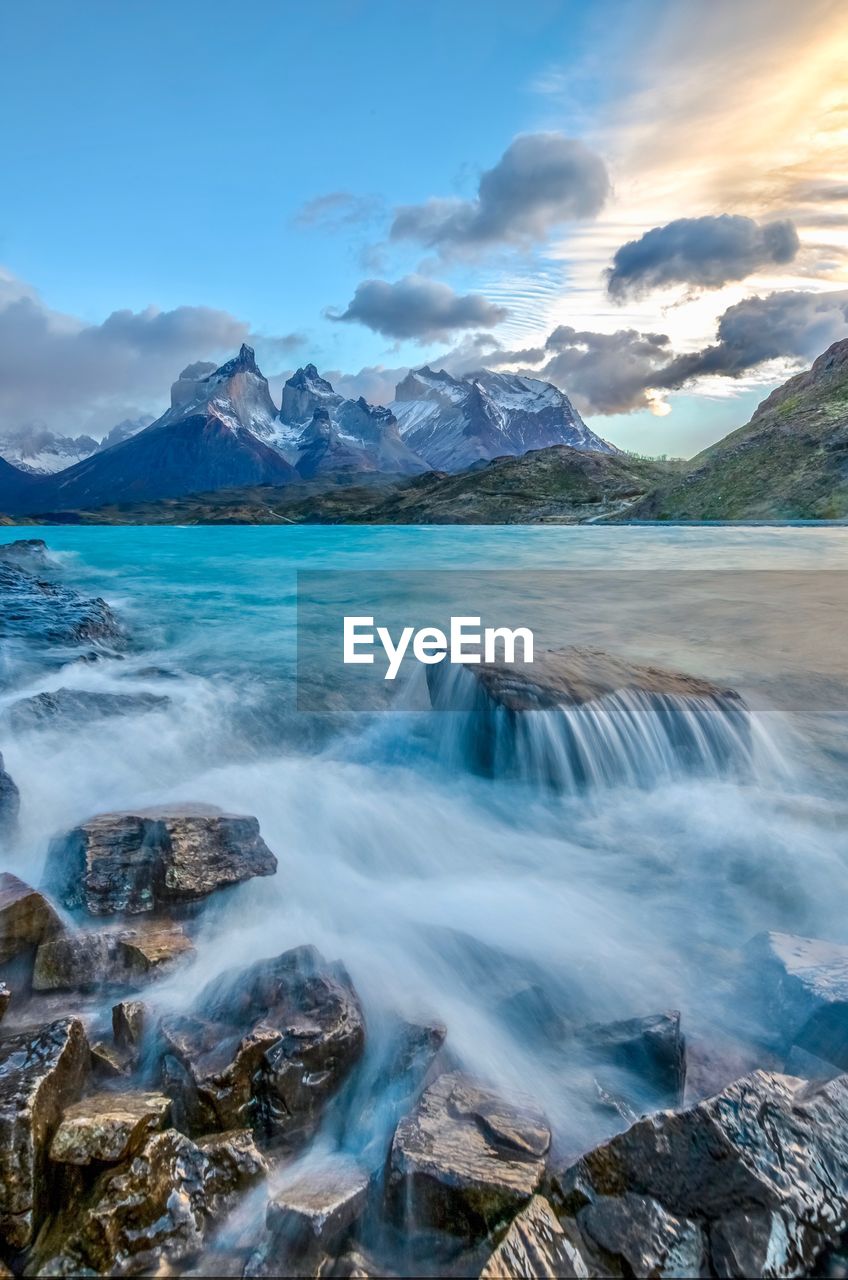 Scenic view of water flowing over a rock