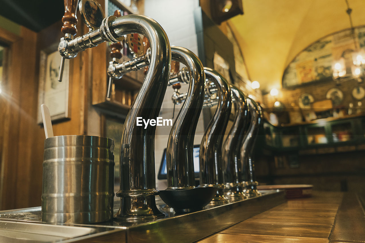 Close-up of beer taps in bar