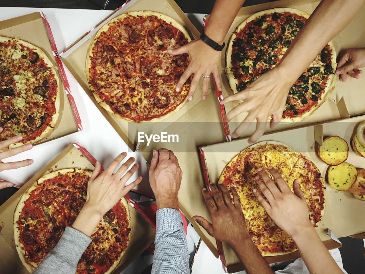 Overhead view of people having pizzas at table