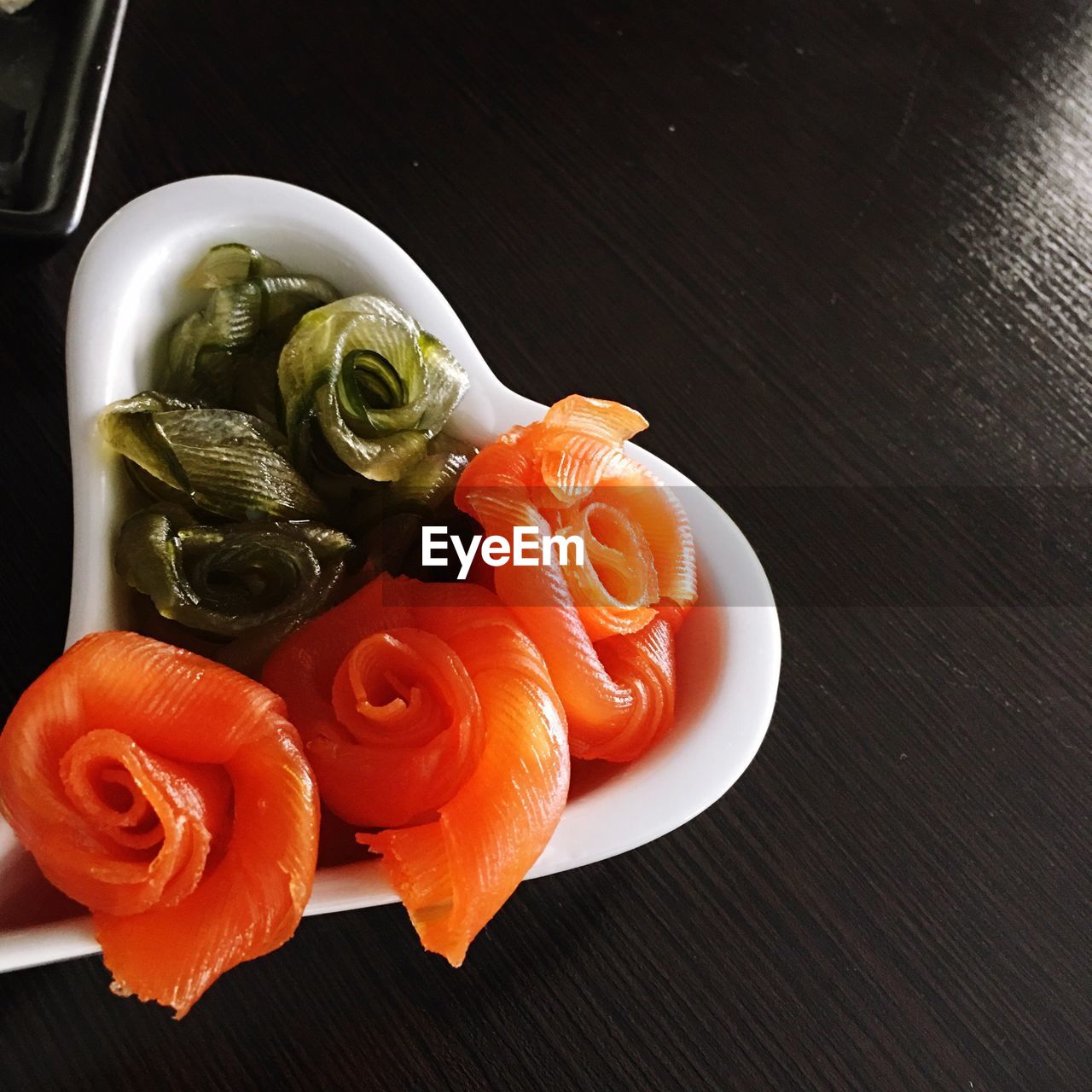 Directly above shot of sashimi in bowl on table