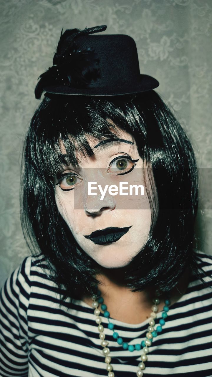 portrait, one person, black, striped, fashion accessory, headshot, clothing, adult, looking at camera, young adult, women, human face, front view, hat, person, hairstyle, indoors, fashion, casual clothing, human hair, black hair, white, close-up, studio shot, female, individuality, human head, long hair, looking, fedora