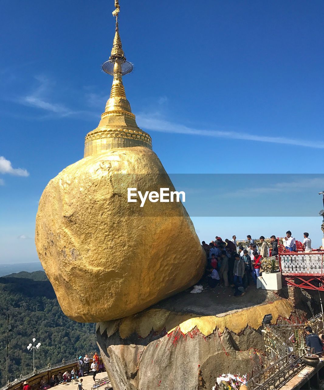 GROUP OF PEOPLE ON ROCK AT TEMPLE