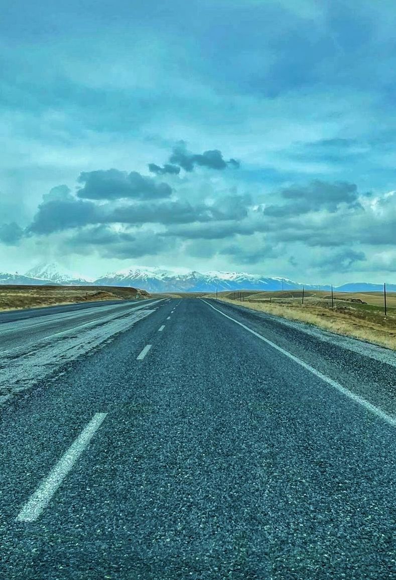 horizon, road, sky, transportation, cloud, asphalt, highway, the way forward, nature, environment, landscape, vanishing point, plain, no people, diminishing perspective, road marking, symbol, sign, marking, land, travel, scenics - nature, infrastructure, field, outdoors, beauty in nature, day, empty road, blue, horizon over land, rural scene, non-urban scene, tranquility, country road, street