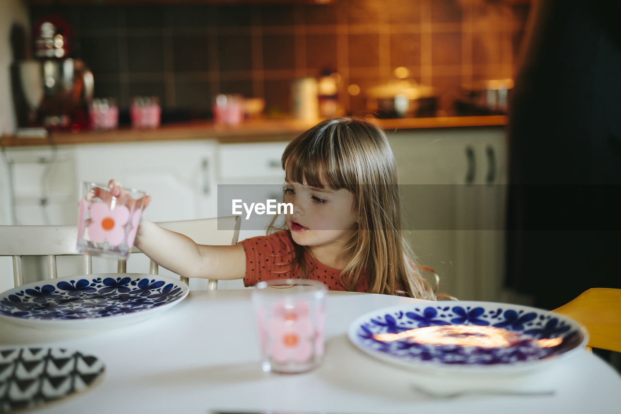 Girl setting table