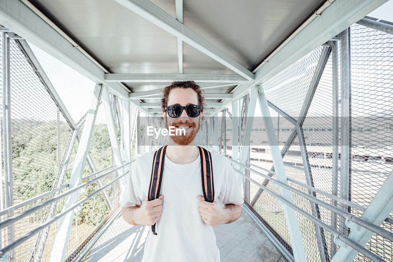 Portrait of man stranding on bridge