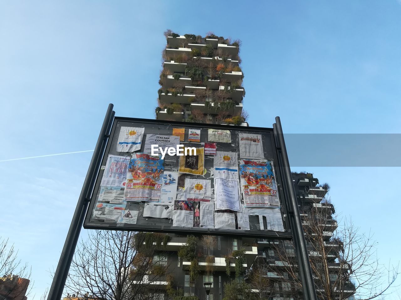 LOW ANGLE VIEW OF TEXT ON BUILDING AGAINST SKY