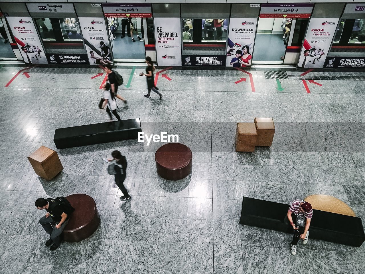 HIGH ANGLE VIEW OF PEOPLE ON TABLE IN EMPTY ROOM